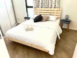 a bedroom with a bed with two slippers on it at Seaside Court Retreat By IsrApart in Tel Aviv