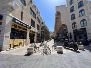 a street with bikes parked in front of buildings at Seaside Court Retreat By IsrApart in Tel Aviv