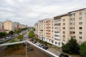 a view of a city street with buildings at Hotel Aria Suites in Târgovişte