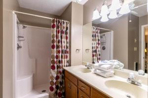 a bathroom with a sink and a shower and a mirror at Grand View in Seven Devils +29 photos