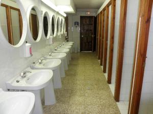 a row of sinks and mirrors in a bathroom at Borda Cortals de Sispony in La Massana