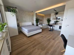 a large room with a bed and a kitchen at Luxury Suite, Villa Joy Verona , Exclusive Romantic Luxury Suite with Jacuzzi, near Verona Center in Verona