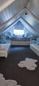 a bedroom with two beds with teddy bears on them at Perlytė in Metelyte