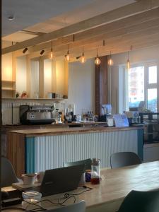 a kitchen with a table with a laptop on it at OZ HOUSE and CAFE in Songiin
