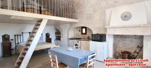 a kitchen with a staircase and a table in a room at Masseria Puglia Antica in Monopoli