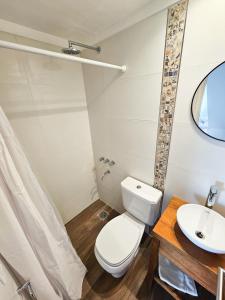 a bathroom with a toilet and a sink at Dúplex Familiar Av 5 y Paseo 117 in Villa Gesell +11 photos