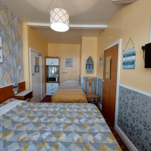 a bedroom with two beds in a room at THE ROCK n ROLL in Blackpool