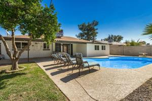a house with a swimming pool with chairs around it at 4 Brdm 6 Beds Pool PetsOK Fenced Yard in Scottsdale
