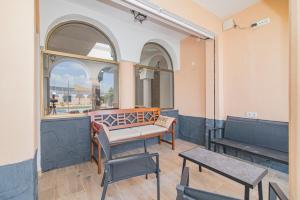 a room with a bench and a table and chairs at Cortijo El Paraíso Granada in Atarfe