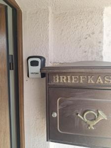 a safe in a room with a barraud sign on the wall at Ferienwohnung Anja in Sonneberg +4 photos