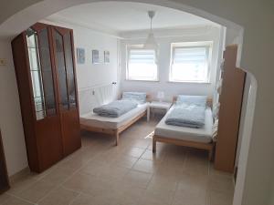 a room with two beds and two windows at Ferienwohnung Anja in Sonneberg