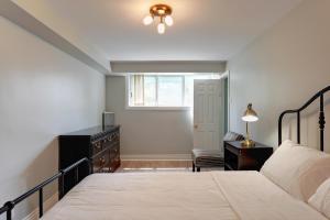 a bedroom with a bed and a dresser and a window at 4 Beds Entire House Wifi Parking in Laval-des-Rapides