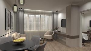 a living room with a table and a bedroom at Feel Athens Studios at Monastiraki in Athens