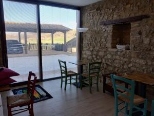 a dining room with a table and chairs and a large window at ElsAnto-beb in San Venanzo