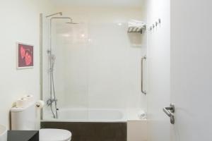 a bathroom with a shower and a toilet at Buendía Corralejo Nohotel in Corralejo