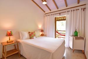 Cama ou camas em um quarto em Casa de Paixão Caraíva