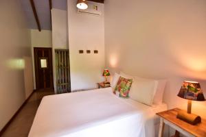 Cama ou camas em um quarto em Casa de Paixão Caraíva