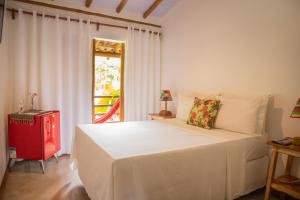 Cama ou camas em um quarto em Casa de Paixão Caraíva