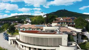 a group of buildings with a mountain in the background at Hotel Golden Key, 4 Stars Superior in Nitra
