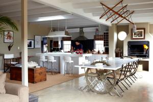 a kitchen and living room with a table and a counter at Explorers Club in Franschhoek