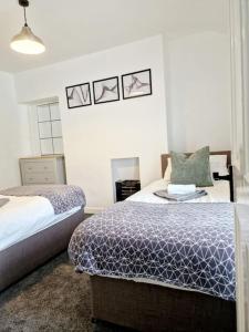 a bedroom with two beds and a mirror in it at Welsh Retreat, BikeParkWales, Brecon Beacons, ZipWorld Tower in Troed-y-rhiw