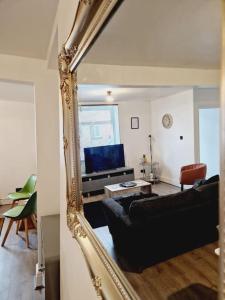 a mirror reflection of a living room with a couch at Welsh Retreat, BikeParkWales, Brecon Beacons, ZipWorld Tower in Troed-y-rhiw +30 photos