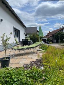 a patio with a hammock and a table and chairs at Ferienwohnung Waldeck in Losheim