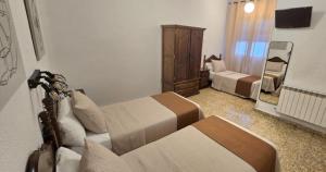 Postel nebo postele na pokoji v ubytování Hostal Prada