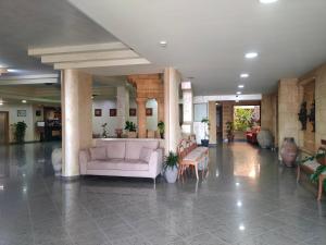 a lobby with a couch and tables in a building at Grand Hotel Mosè in Villaggio Mosè +41 photos