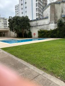 a swimming pool in a city with tall buildings at Póvoa Mar in Póvoa de Varzim