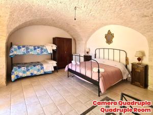 a bedroom with two beds in a room at Masseria Puglia Antica in Monopoli