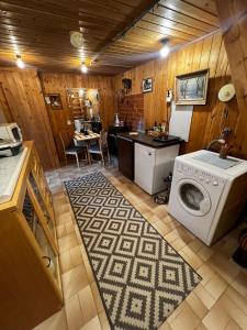 a kitchen with a washing machine in a room at Narikka Cottage, Cozy Stay in Central Kittilä, Near Levi Ski Resort in Kittilä