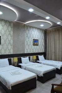 Ένα ή περισσότερα κρεβάτια σε δωμάτιο στο Pearl Tashkent