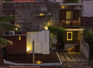a house with lights on the side of it at Happy House BnB Bromo backpacker in Probolinggo