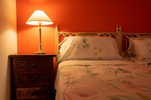 a bedroom with a bed and a lamp on a night stand at Mirador 2 del Mercado Central - habitacion con baño privado en el centro de la Ciudad Vella in Valencia