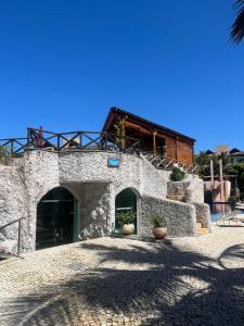 a large stone building with a building at Cobertura Parque das Ilhas in Mangabeira