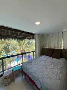 a bedroom with a large bed and a large window at Cobertura Parque das Ilhas in Mangabeira +25 photos