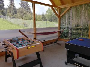 a games room with a foosball table and avertisement for avertisementosate at Mounty vendégház in Borzont