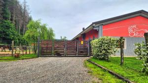 a barn with a gate and a red building at Casa Vacanze i Salici in Viggiù +22 photos