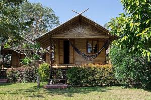 a small house with a hammock in front of it at Luhngam Homestay in Mon
