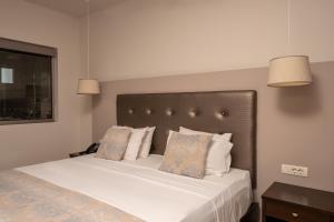 Postel nebo postele na pokoji v ubytování Oscar Hotel