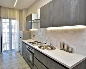 a kitchen with a sink and a stove at Very beauty new apartment for good guests in Arabkir