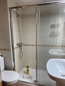 a bathroom with a shower and a toilet and a sink at Sea City Torremolinos Beach in Torremolinos