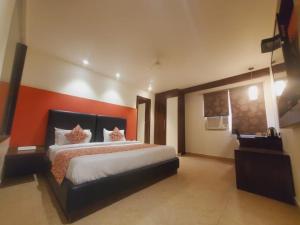 a bedroom with a bed with two cats on it at love kush hotel in Nagla Dhīmar