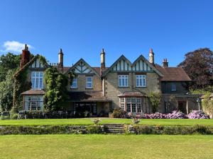 a large house with a lawn in front of it at Bank House Longtown in Longtown