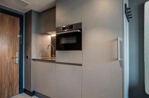 a kitchen with a sink and a microwave at The Gate London City in London