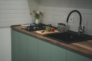 a kitchen counter with a sink and a cutting board at Room&Garden in Mtskheta +9 photos
