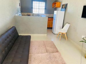 a living room with a couch and a refrigerator at plot 38 self catering apartment and camping in Khemsbok