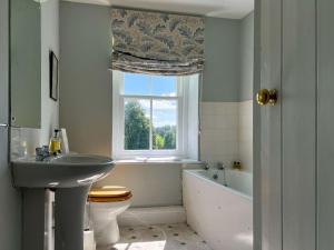 a bathroom with a sink toilet and a window at Kirk House Longtown in Longtown +36 photos
