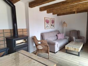 a living room with a couch and a stove at La Palmera Casa Rural in L'Aldea
